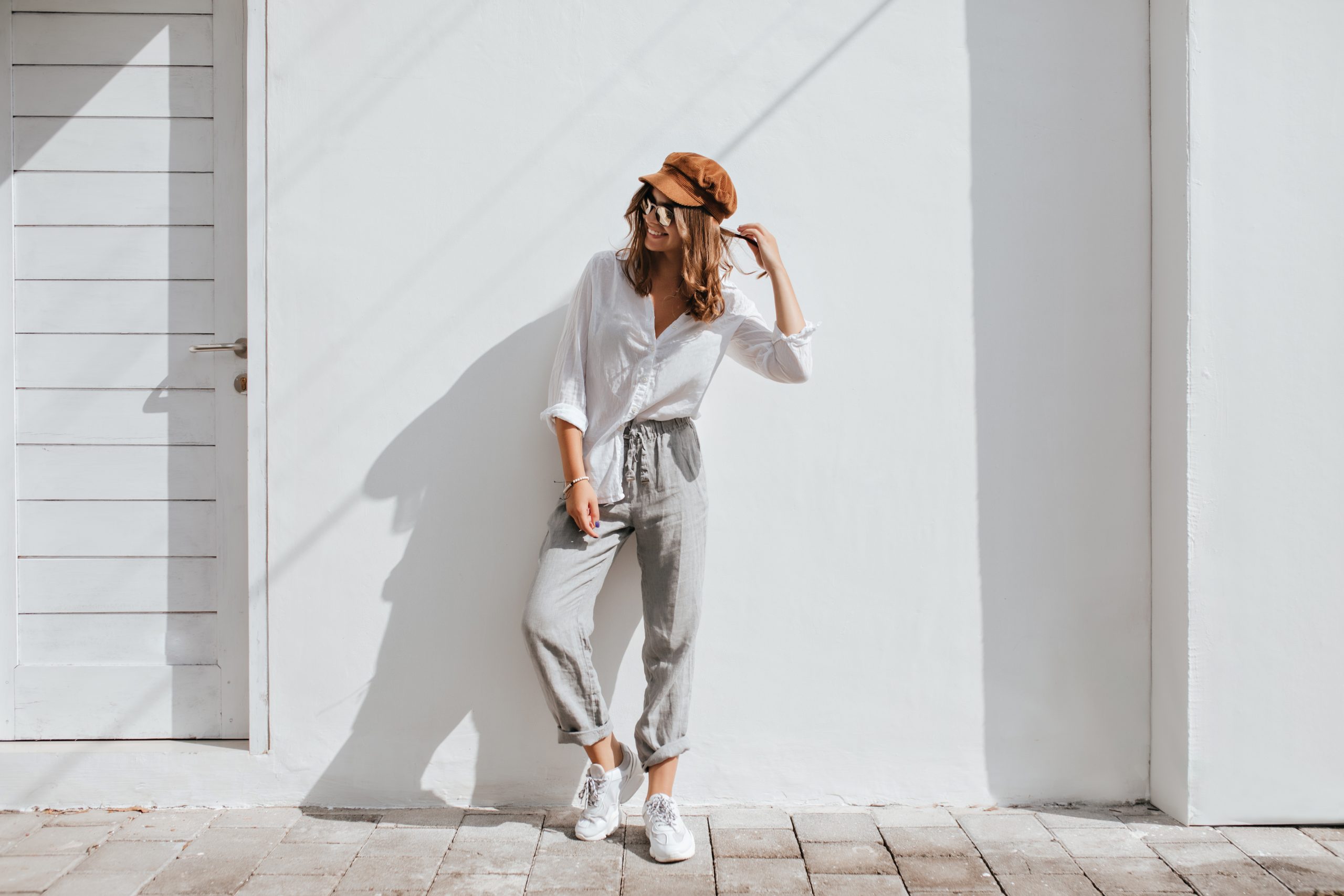 Stylish,Girl,In,Gray,Pants,And,White,Cotton,Blouse,Posing